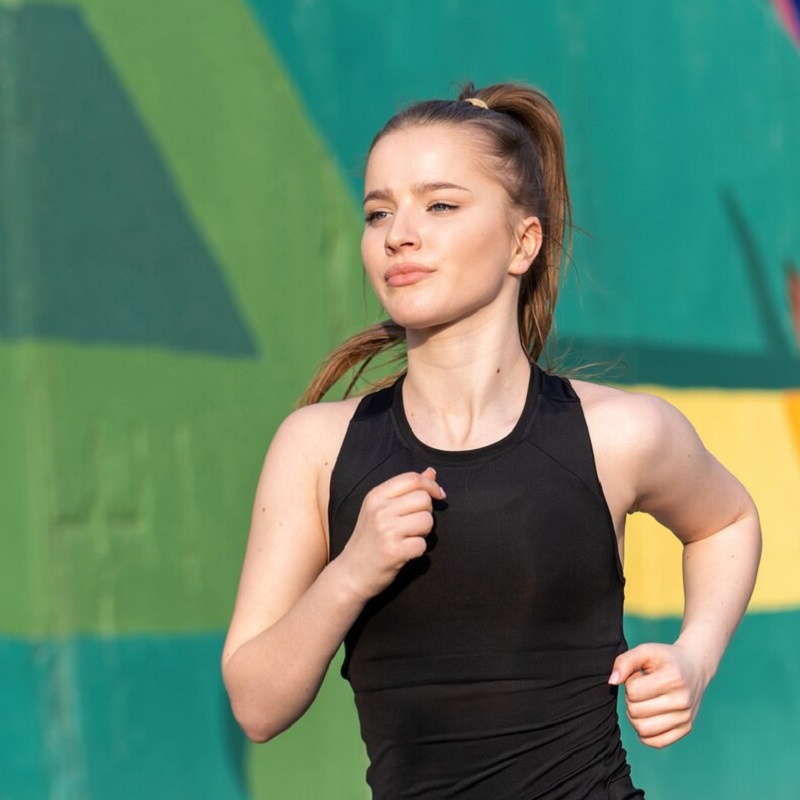 young-blonde-woman-sportswear-running-road-outdoors-training-multicolored-wall-background_1268-17559